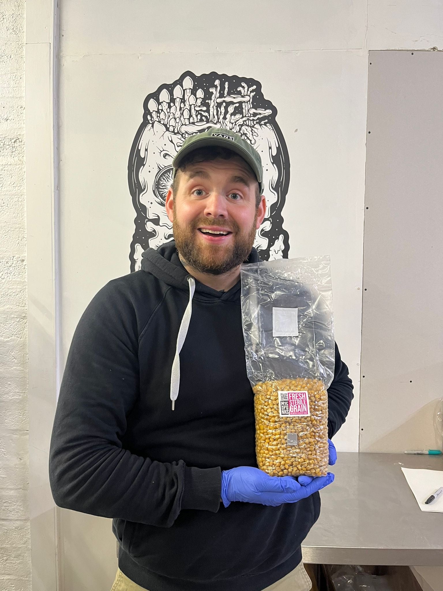 MycoPunks Sam holding a bag of popcorn in the MycoPunks showroom